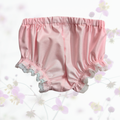 Pink baby bloomers with lace trim