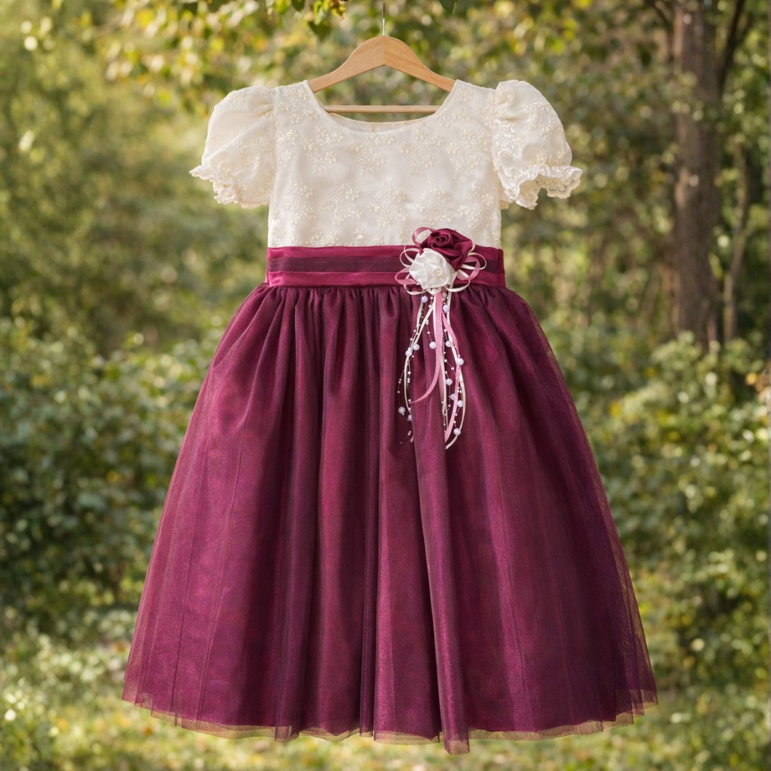 White dress with puffed sleeves and a burgundy skirt with a bow